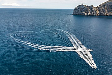 A group of boats are floating in the ocean