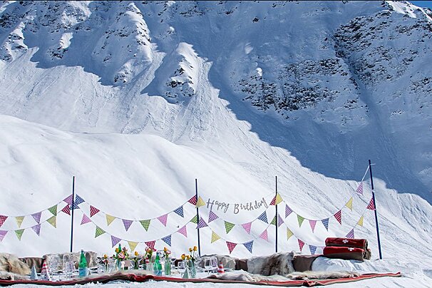 A snowy mountain with a sign that says happy birthday