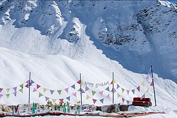 A snowy mountain with a sign that says happy birthday