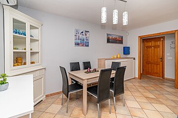 A dining room with a table and chairs in it
