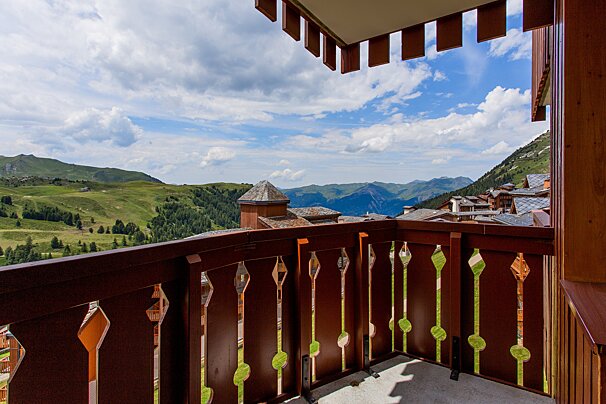 A balcony with a view of a mountain range