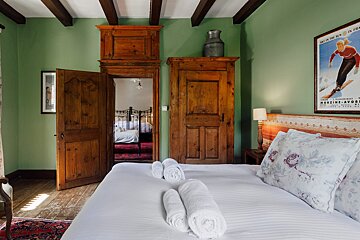 A bedroom with a poster of a skier on the wall