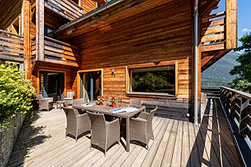 A wooden deck with a table and chairs on it