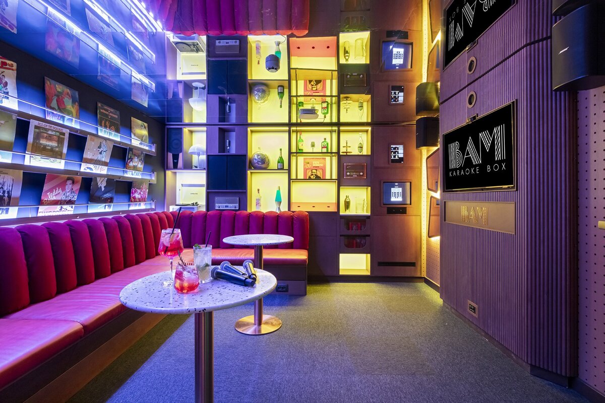 A room with a sign that says bam karaoke box