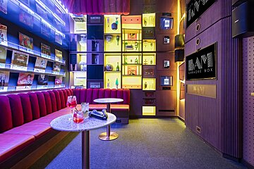 A room with a sign that says bam karaoke box