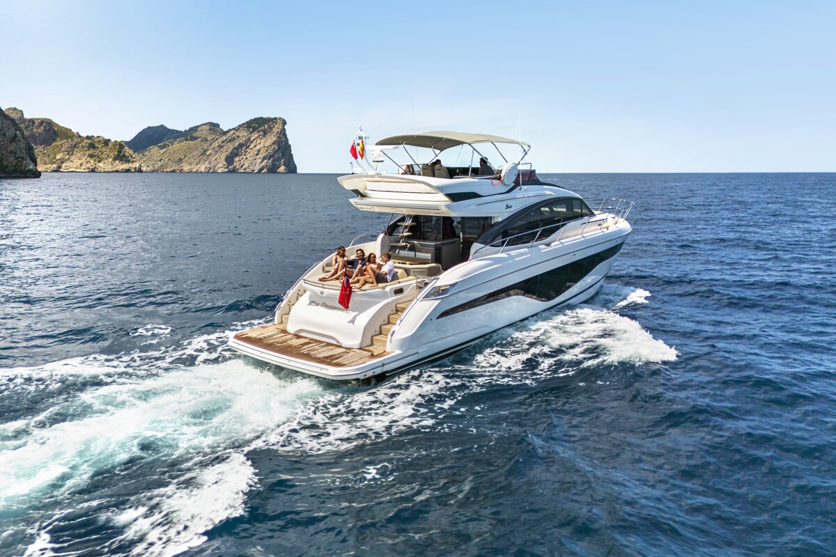 A large white yacht is floating in the ocean