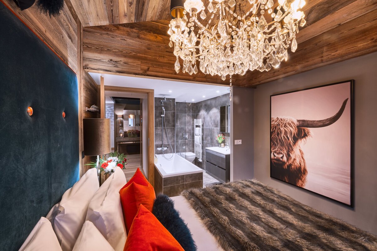 A bedroom with a picture of a bull on the wall