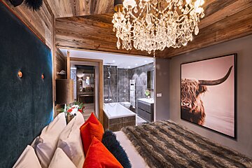 A bedroom with a picture of a bull on the wall