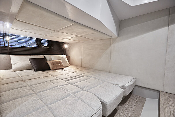 A bed with a blanket and pillows on it