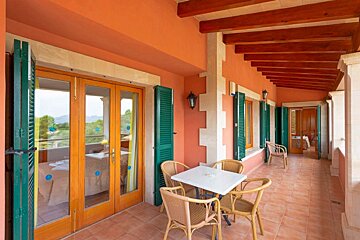 A balcony with a table and chairs on it