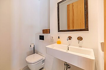 A bathroom with a toilet a sink and a mirror