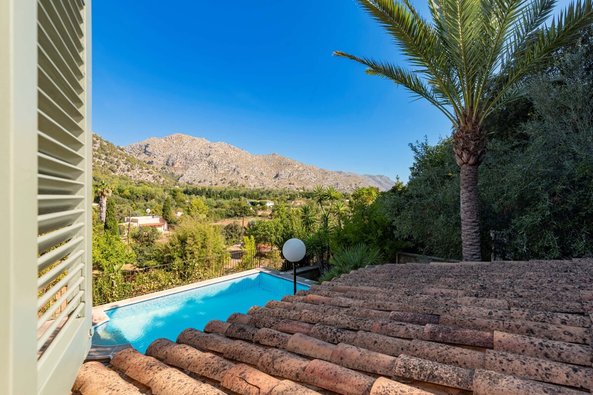 A view of a swimming pool with mountains in the background