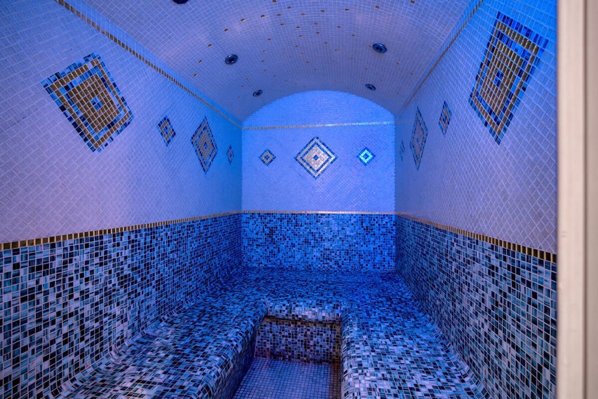 A blue and white tiled room with a ceiling
