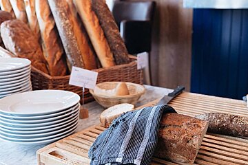 A loaf of bread is sitting on a wooden cutting board