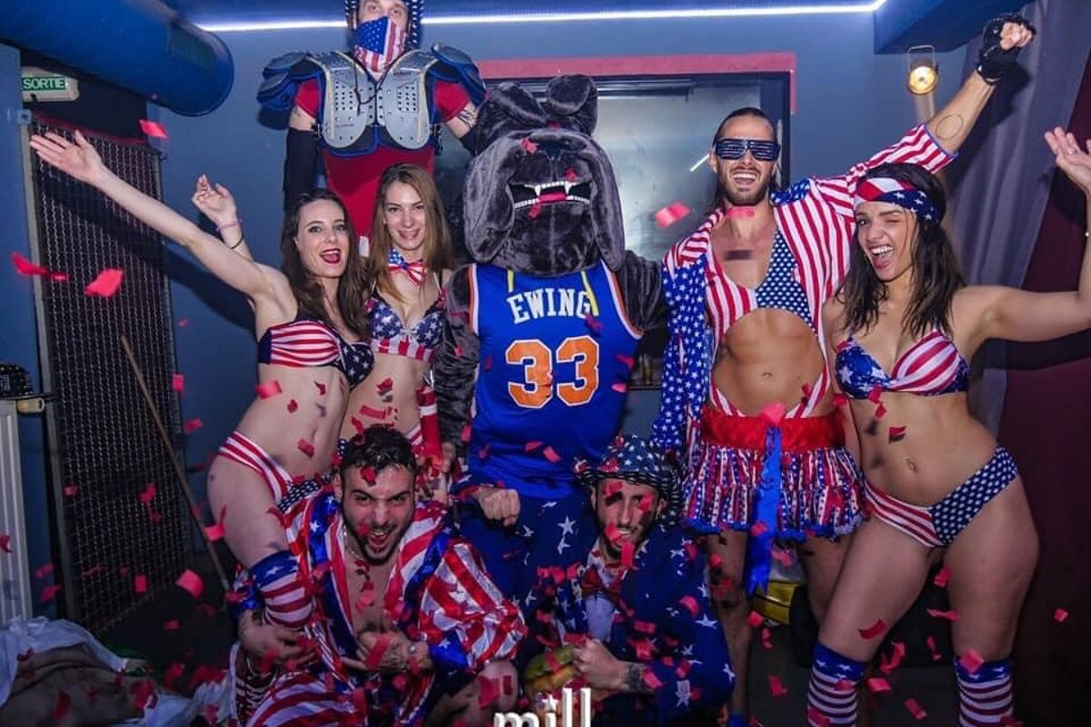 A group of people posing for a photo with a mascot wearing a jersey with the number 33 on it