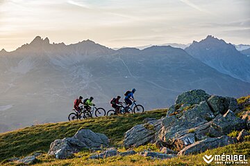 Mountain bikers cycling uphill in Meribel