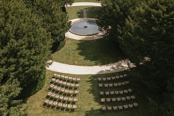 Rows of chairs are lined up in front of a fountain