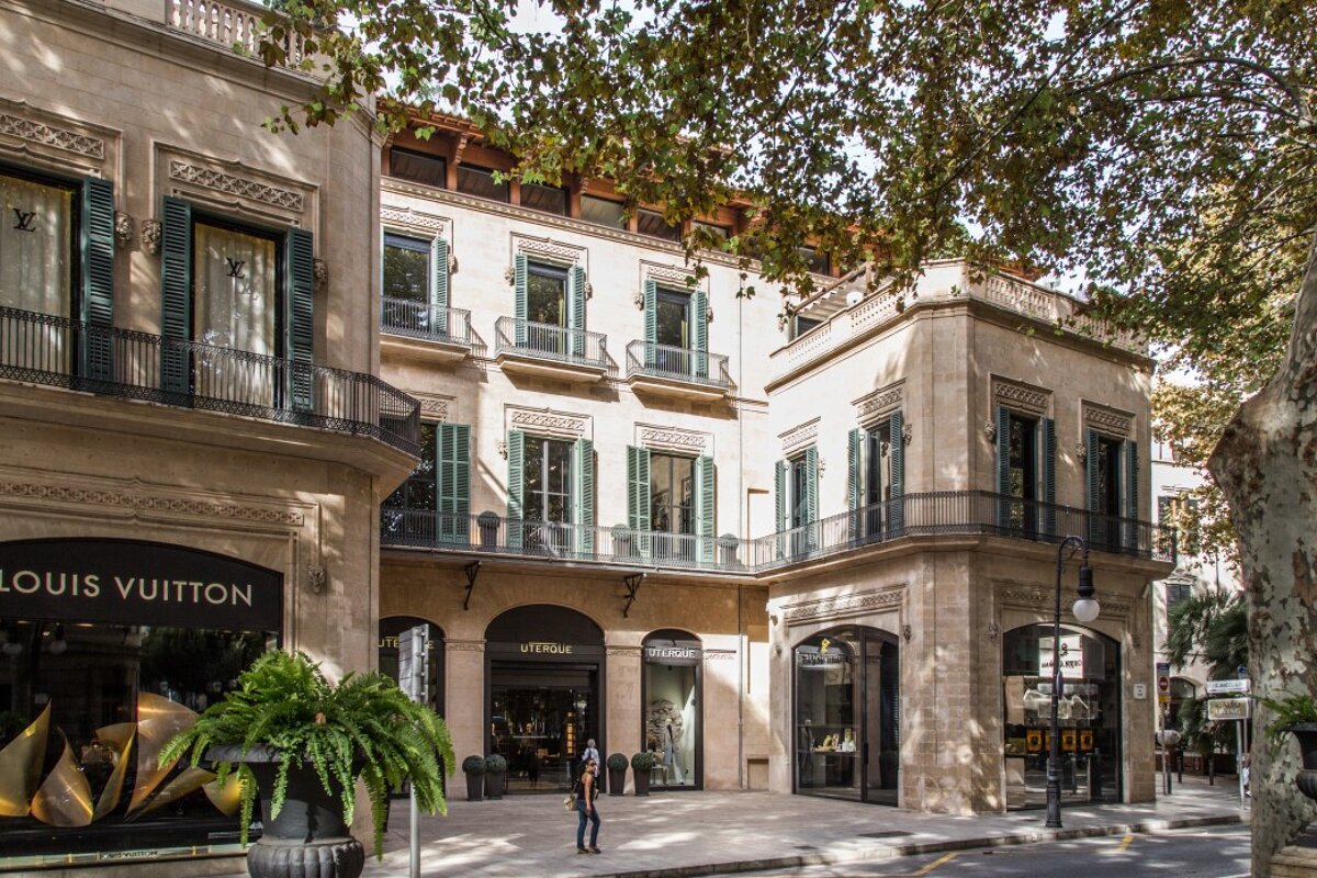 A louis vuitton store is on the corner of a building