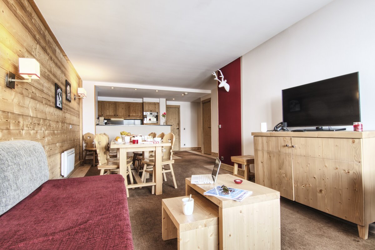 A living room with a couch and a flat screen tv