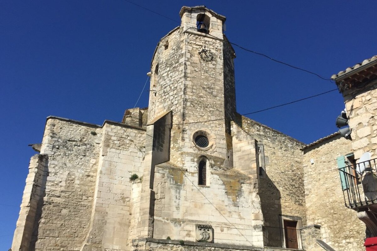 a stone tower in a village in provence