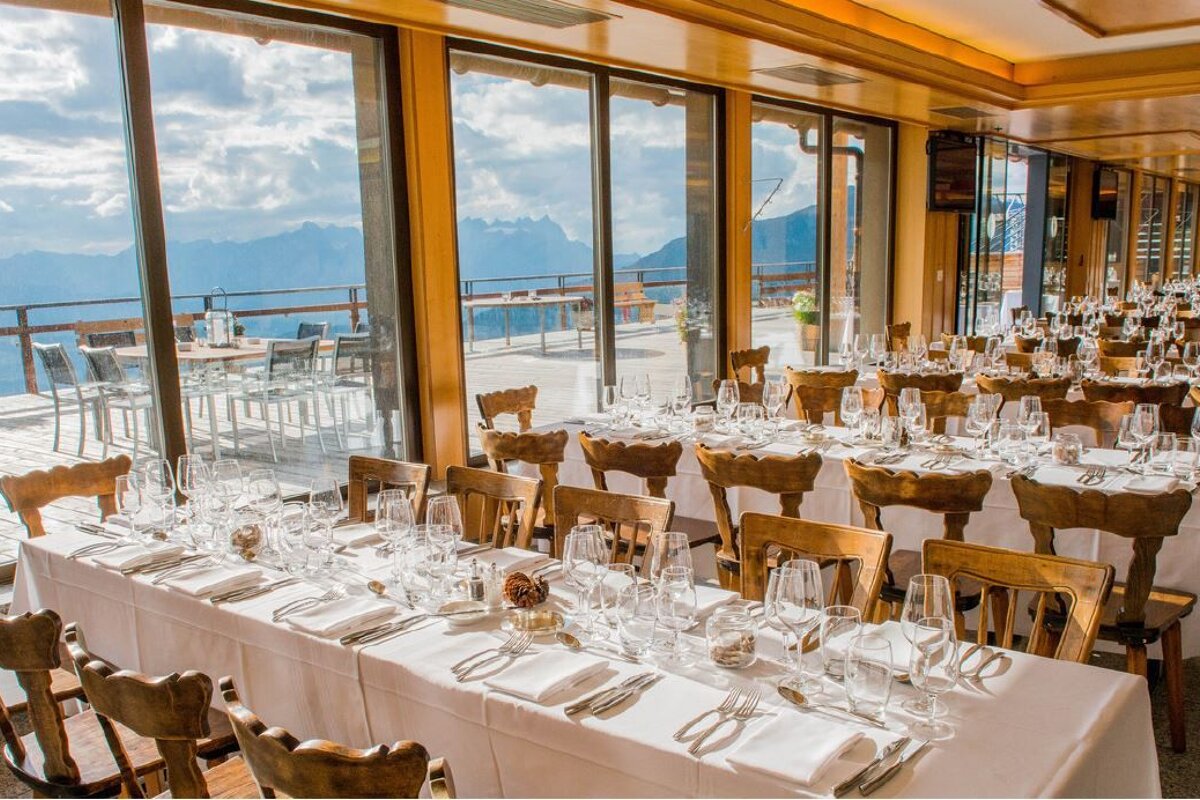 A restaurant with a view of the mountains is set up for a wedding reception