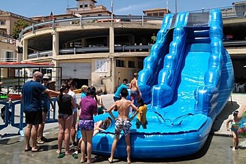 a blue inflatable waterslide at port calanova in mallorca