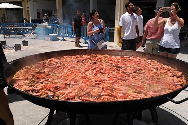 a metal dish filled with paella in port calanova