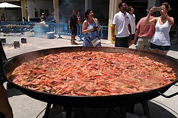 a metal dish filled with paella in port calanova