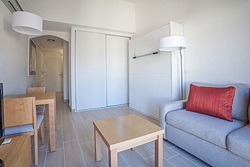A living room with a couch table and chairs