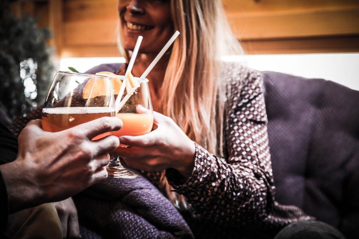 A man and a woman are toasting with drinks