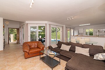 A living room with a brown couch and a brown chair