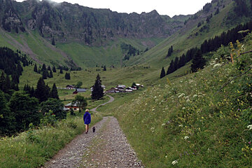 a woman and a dog on a hiking trail in Morzine