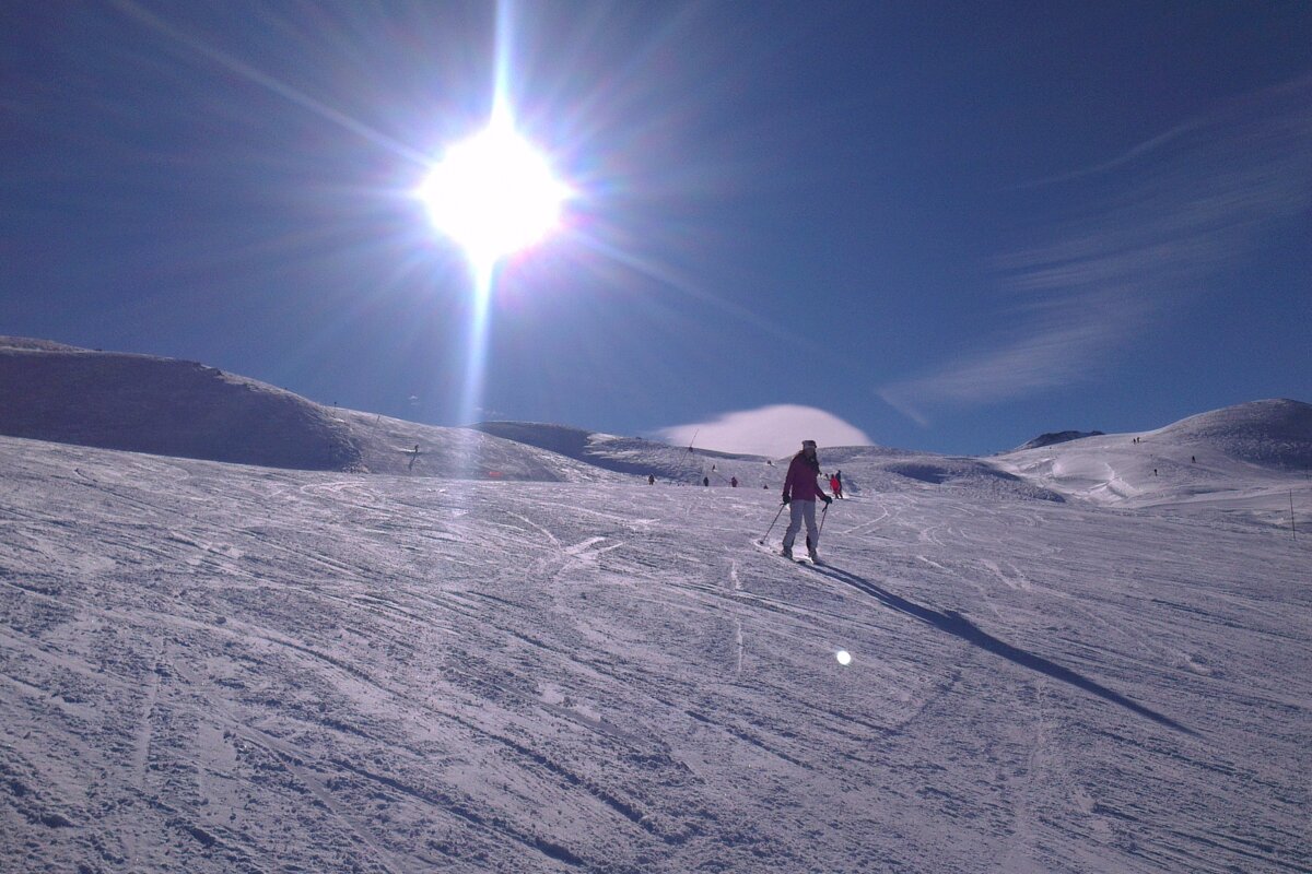 skier on piste blue skies