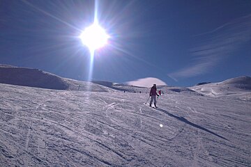 skier on piste blue skies