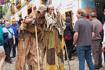 stilt walkers roam the crowds in dalt Vila at medieval festival ibiza