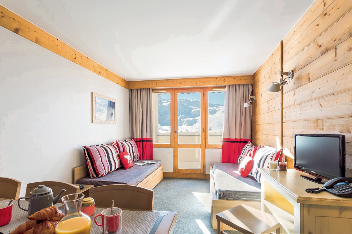 A living room with a couch and a television