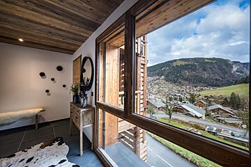 A large window with a view of a mountain village