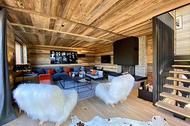 A living room with furry chairs and a couch