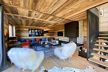 A living room with furry chairs and a couch