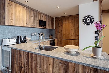 A kitchen with a sign that says vall d' isere 9