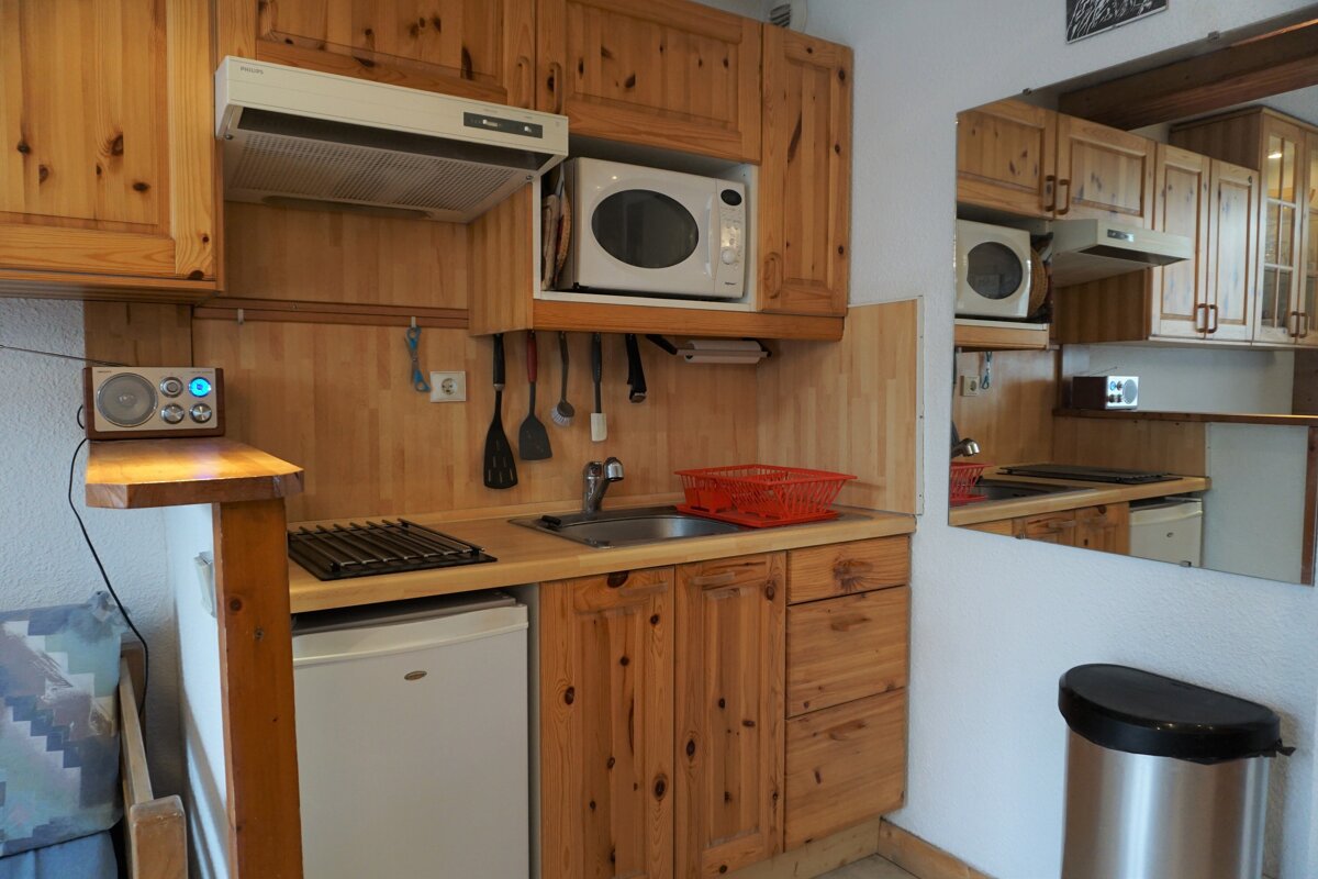 A small kitchen with a microwave and a sink