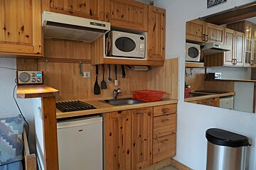 A small kitchen with a microwave and a sink