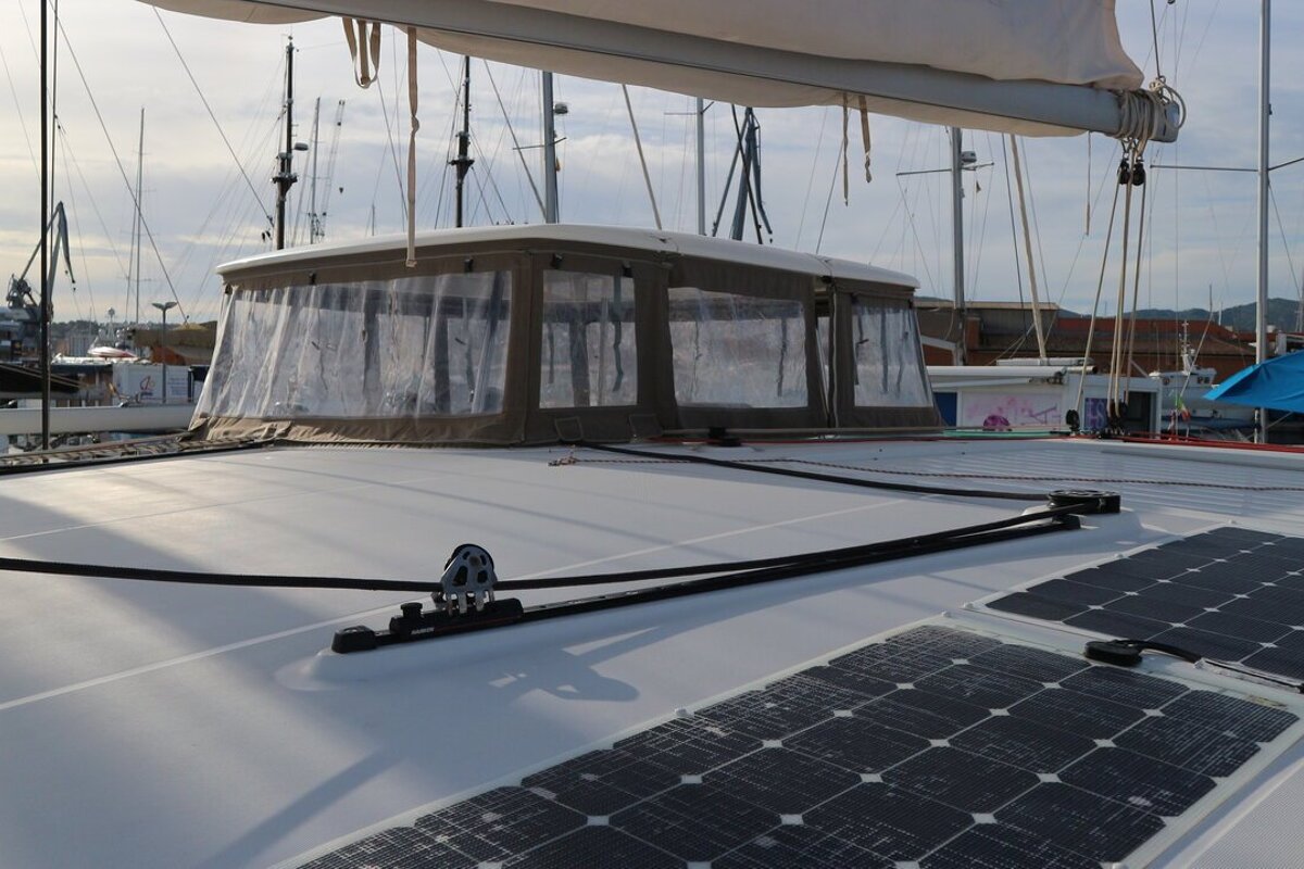 A sailboat with solar panels on the deck