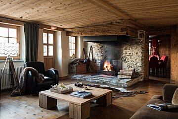 A living room with a fireplace and a coffee table