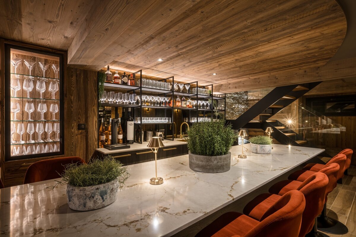 A bar with a lot of wine glasses on the shelves