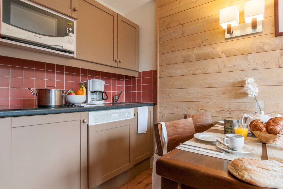 A kitchen with a microwave and a coffee maker