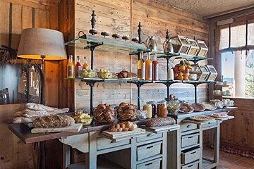 A buffet table with bread and fruit on it