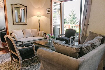 A living room with a couch and two chairs