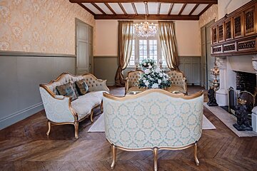 A living room with two couches and a fireplace