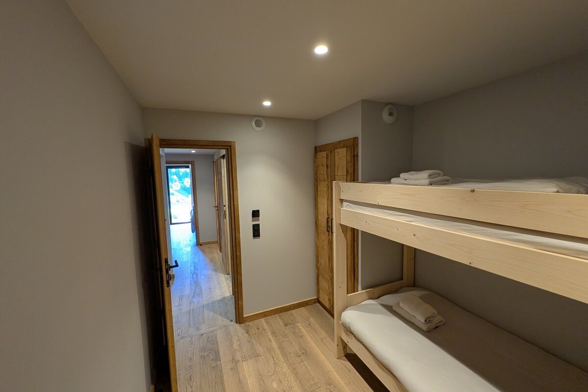 A bedroom with bunk beds and a doorway